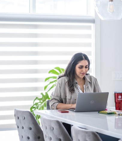 Student sitting in their home working on their laptop