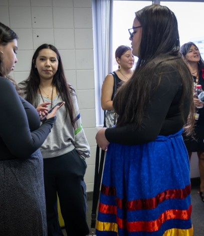 students stand in a circle chatting