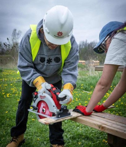 trades workshop at the CTFN, a person uses a circular saw