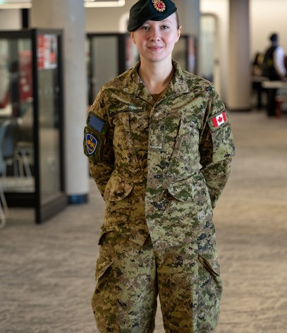 A military member in her uniform posing for a picture