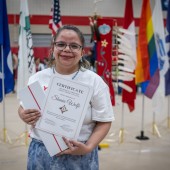woman holds indigenous community impact award