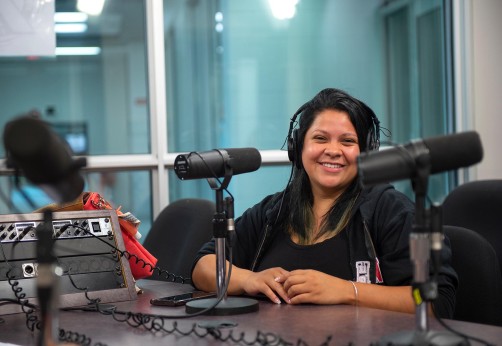 Student smiling in audio booth