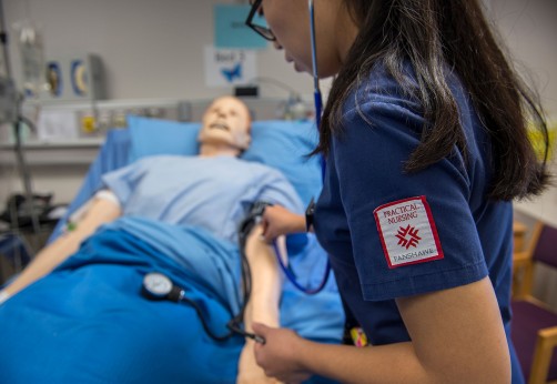Nursing student working on dummy patient