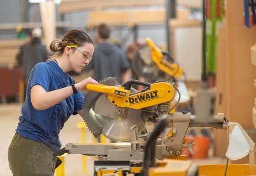 Fanshawe student using a chop saw