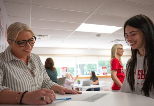 A teacher is talking with a student