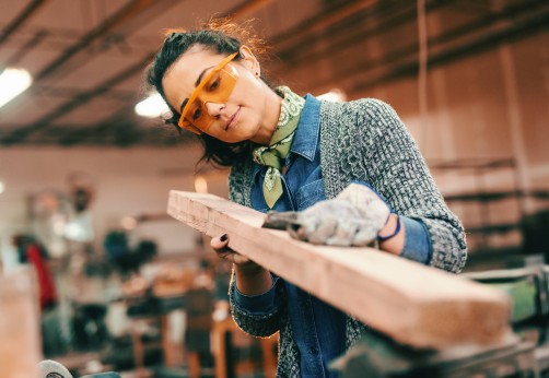 woman works with lumber