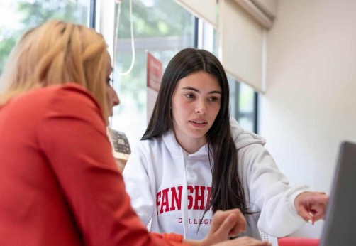 student points at screen while getting support from career services consultant