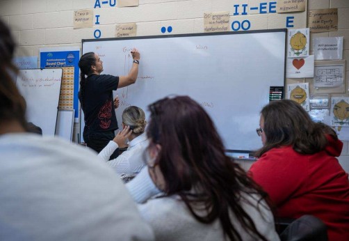 instructor writes on whiteboard in Indigenous Language Program