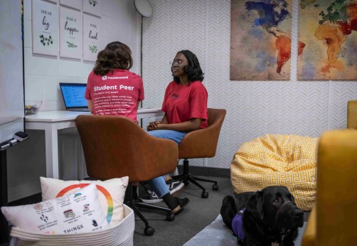 Peer support student speaking with another student in the kind space