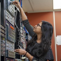 Student changing wires in networking lab