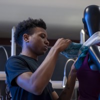 Fashion Marketing and Management student, setting up merchandise in Live Chic store