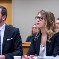 Two students in mock trial looking at judge
