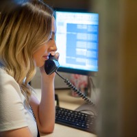 Admin assistant on a phone call at a desk