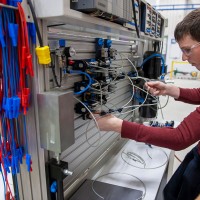 Two guys working on electrical board