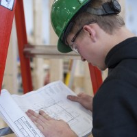 Fanshawe Carpentry student, reviewing plans in workshop