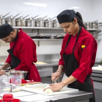 Culinary students preparing food in culinary lab
