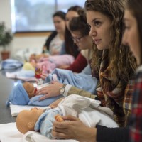 Students in doula class, paying attention to instructor