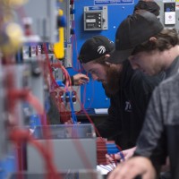 Students working in electronics lab at Fanshawe College with instructor assisting