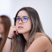 Student in class with curious look on her face