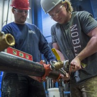 Fire Safety Systems students working on fire safety equipment