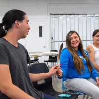 Student sitting a circle passing a feather around