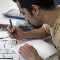 Student working on interior decorating assignment in class