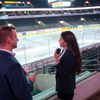 Two people in an arena in suits