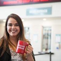 Alumni holding cup at budweiser gardens
