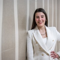 A female accounting student smiling and posing for a picture in a hallway on the Fanshawe College campus.