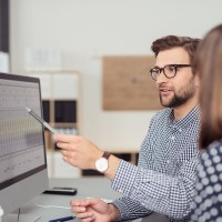 Researchers reviewing data on a spreadsheet