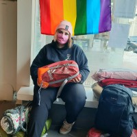 Photo of youth holding a new backpack