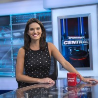 Caroline Cameron smiles from behind desk on Sportsnet