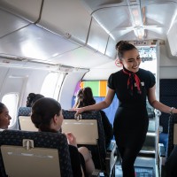 Flight Services student talking to airplane passsengers