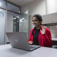 counsellor waves at camera during online appointment