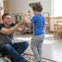 teacher and student play together in classroom