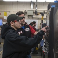 A student working with a CNC Machine