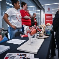 Open House Attendees and program representatives engage with anatomical models at the Veterinary Technician display during Fanshawe College's Open House event.