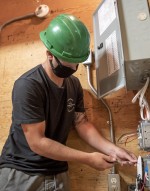 Electrician - Construction and Maintenance student working on electrical panel