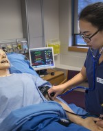 Nursing student checking a mannequin