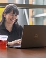 students sits at table with laptop and snacks