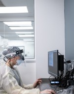 dental worker sits in PPE in front of computer