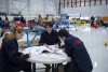 Students working together at a table in the hangar at the Norton Wolf School of Aviation Technology