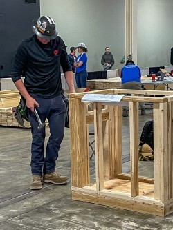 A man with a hammer works on a project