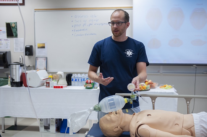 Professor gives instruction to students on intubating a patient