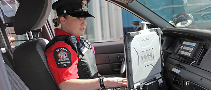 Photo of Special Constable sitting in the front seat in vehicle