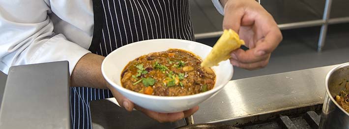 Chef garnishing chili