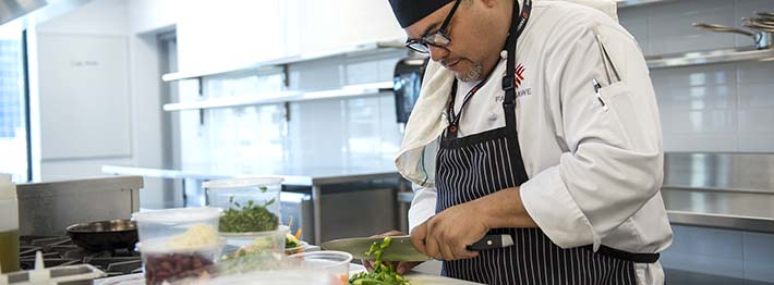 Chef chopping peppers for chili