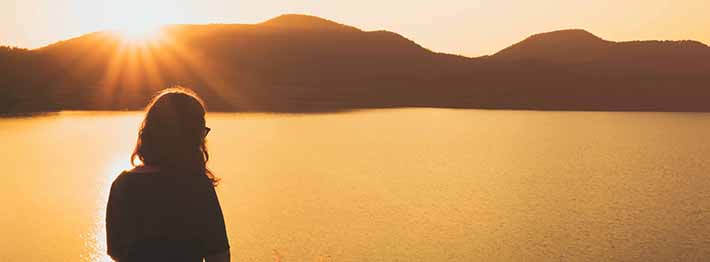 woman watching sunset