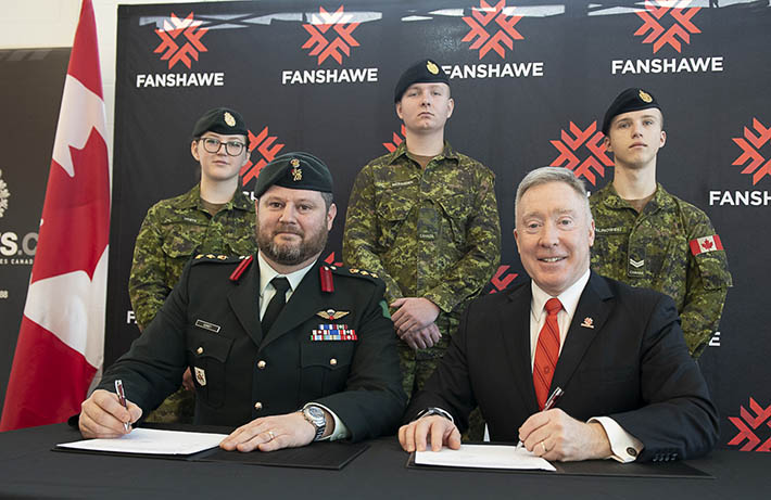 Colonel Jason Guiney and Fanshawe President Peter Devlin sign an MOU