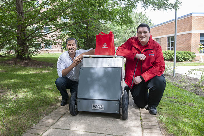 Brennan Berlemont and Ahmed Safadi with their delivery drone